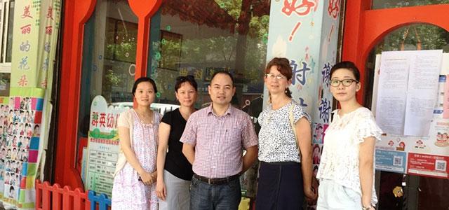 Jyu-Lin Chen (second from left) stands with colleagues from Central South University at a preschool research site visit.