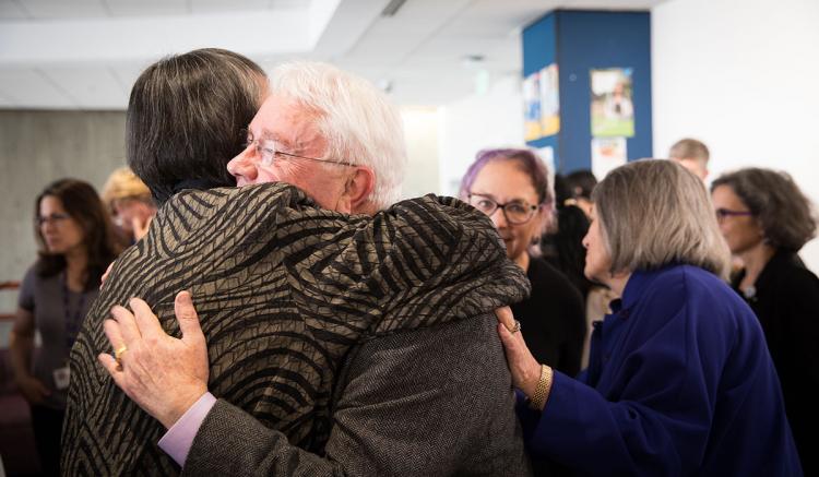 Cliff Morrison hugs Marilyn Chow. Morrison and Chow are depicted in the new mural celebrating diverse nursing heroes. (Photography by Elisabeth Fall)