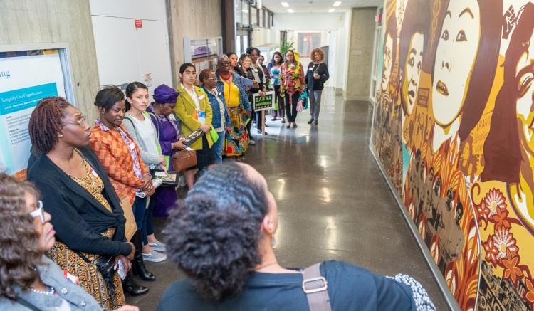 Conference attendees view the School of Nursing's Difference is Power mural.