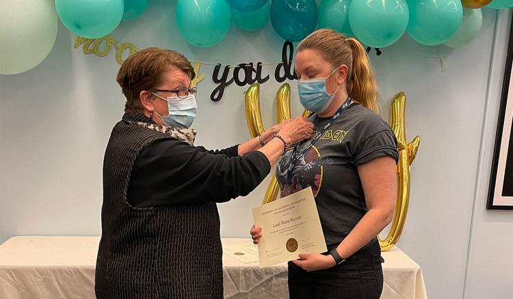 Liesl Piccolo receives her pin from MEPN Interim Director Mary Foley.