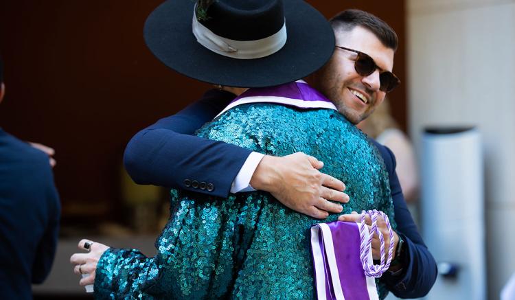 Student Ross Theriot hugs classmate Garrett Reid at the MEPN Pinning Ceremony.