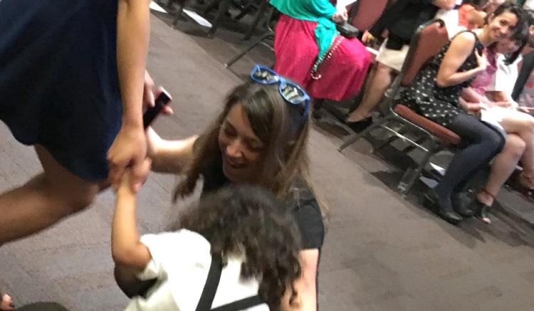 Family enjoys a moment of celebration as the crowd gathers for the start of the pinning ceremony.