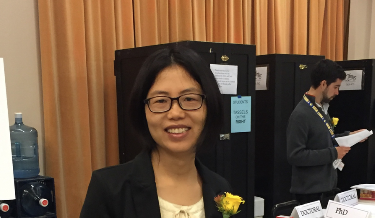Student Affairs team member XinXin awaiting arrival of this year's graduates.