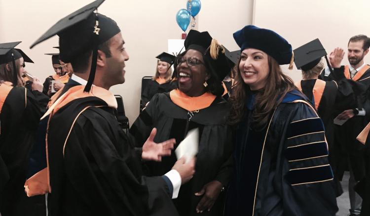 Keynote speaker and distinguished guest Sheila Antrum mingles with the graduates before the ceremony.