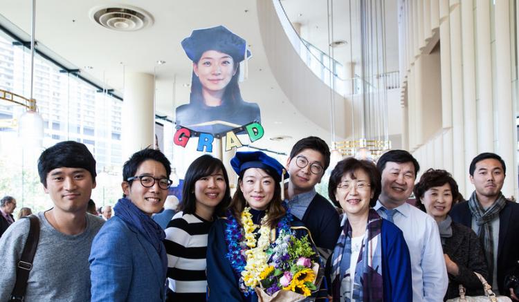 2016 grad poses with her family following commencement.