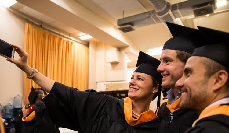 Group of students take a selfie at 2016 commencement ceremony.