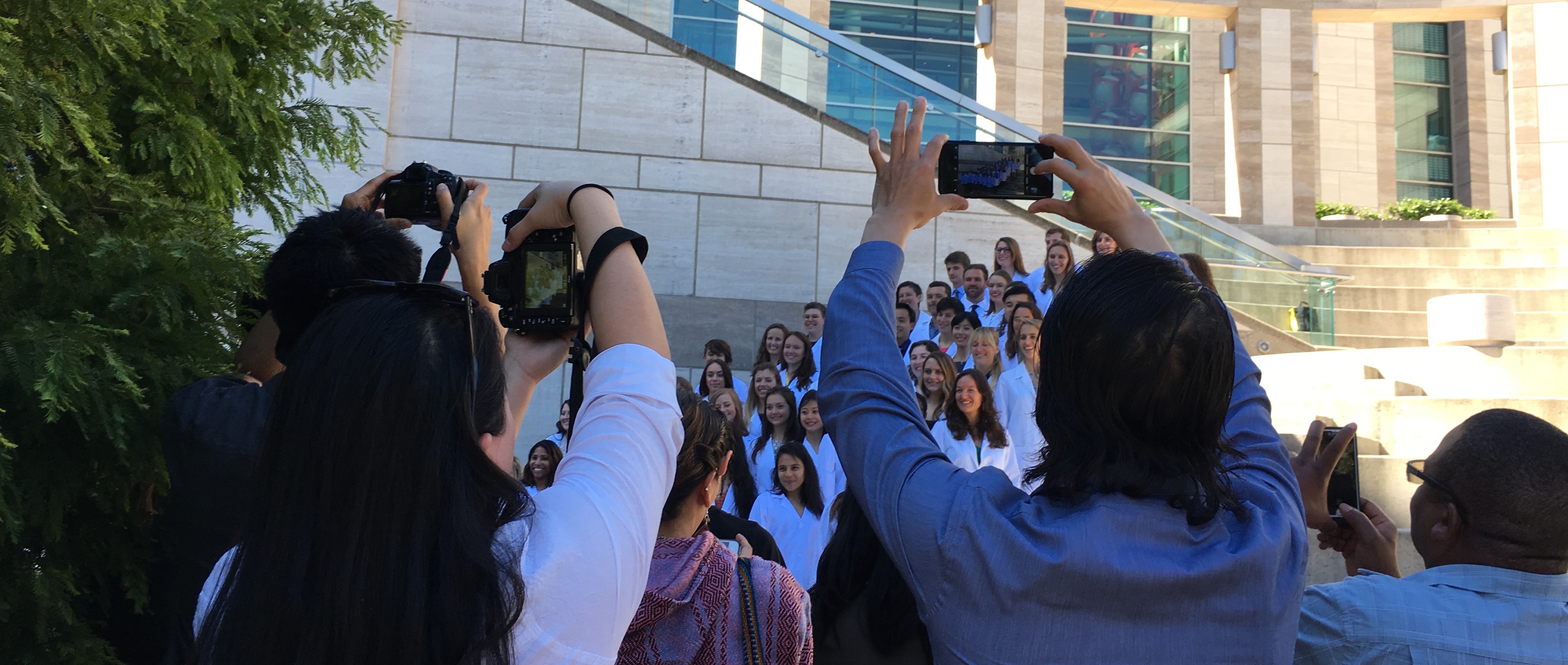 Families take photos of the MEPN students at their White Coat Ceremony