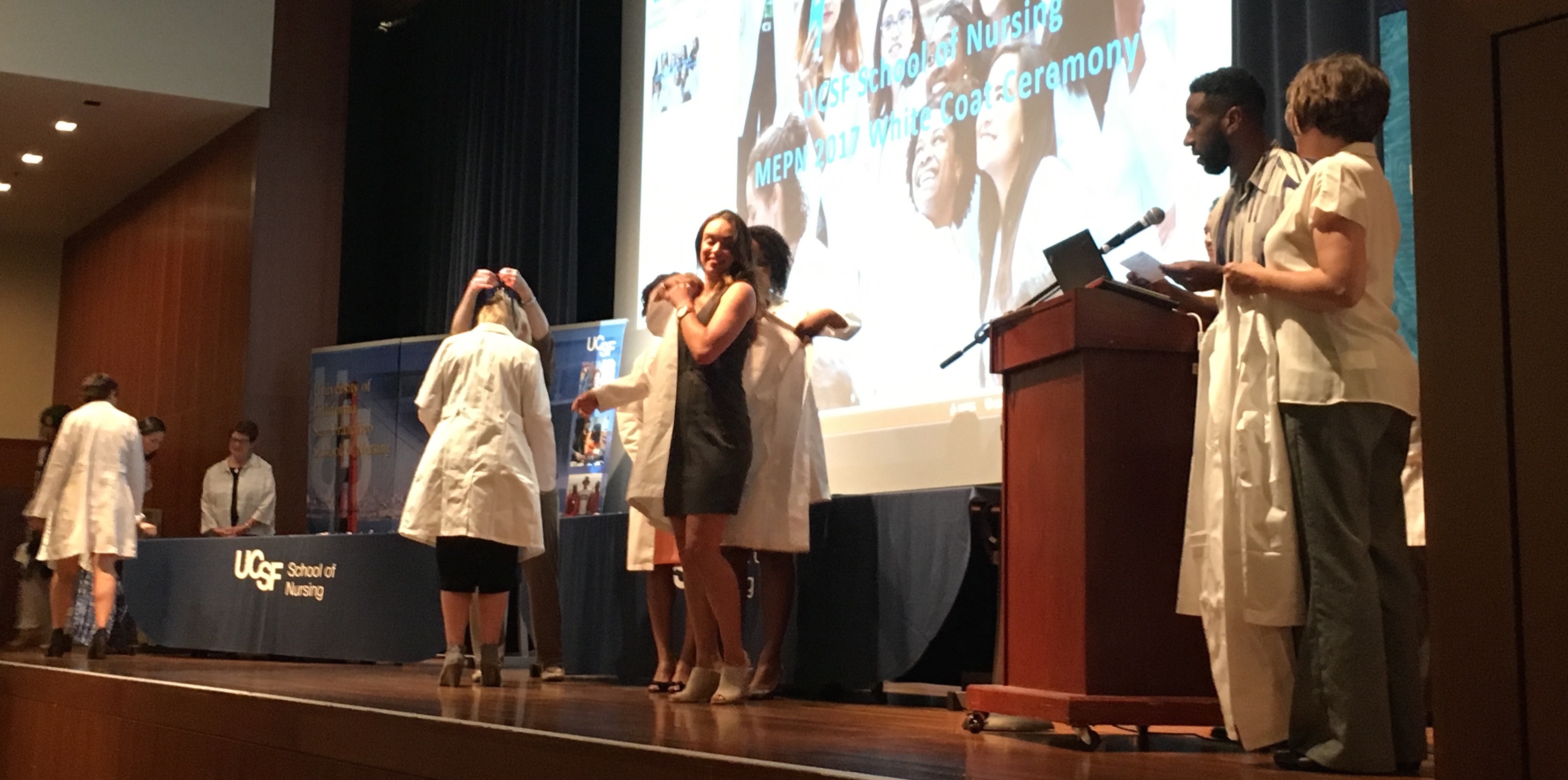 Students receiving their white coats and pins