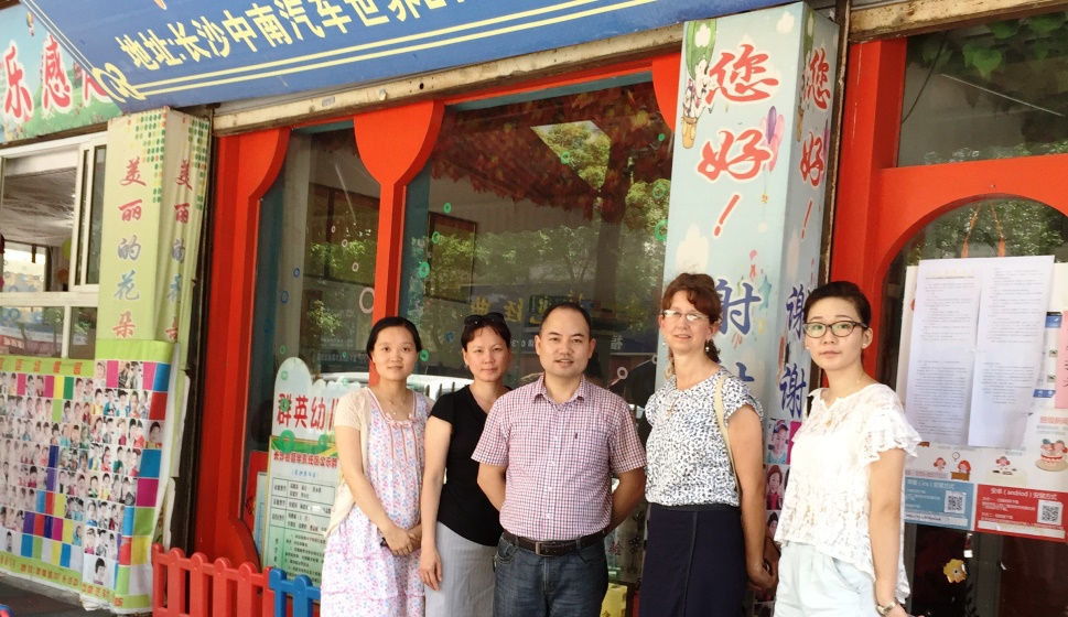 Jyu-Lin Chen (second from left) stands with colleagues from Central South University at a preschool research site visit.