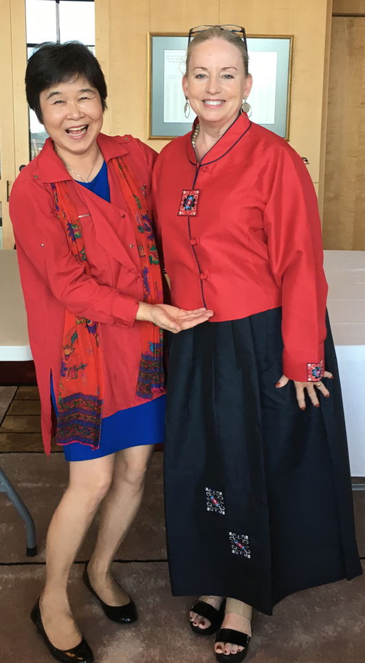 Professors Hong and Fleming pose in lange room following graduation