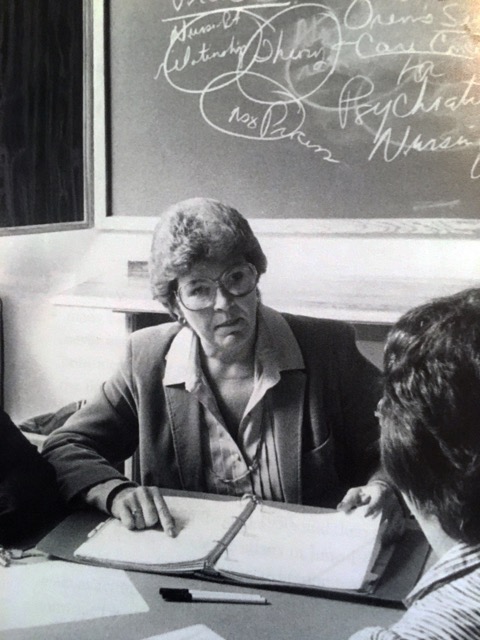 Photograph of Patricia Underwood conferring with a colleague