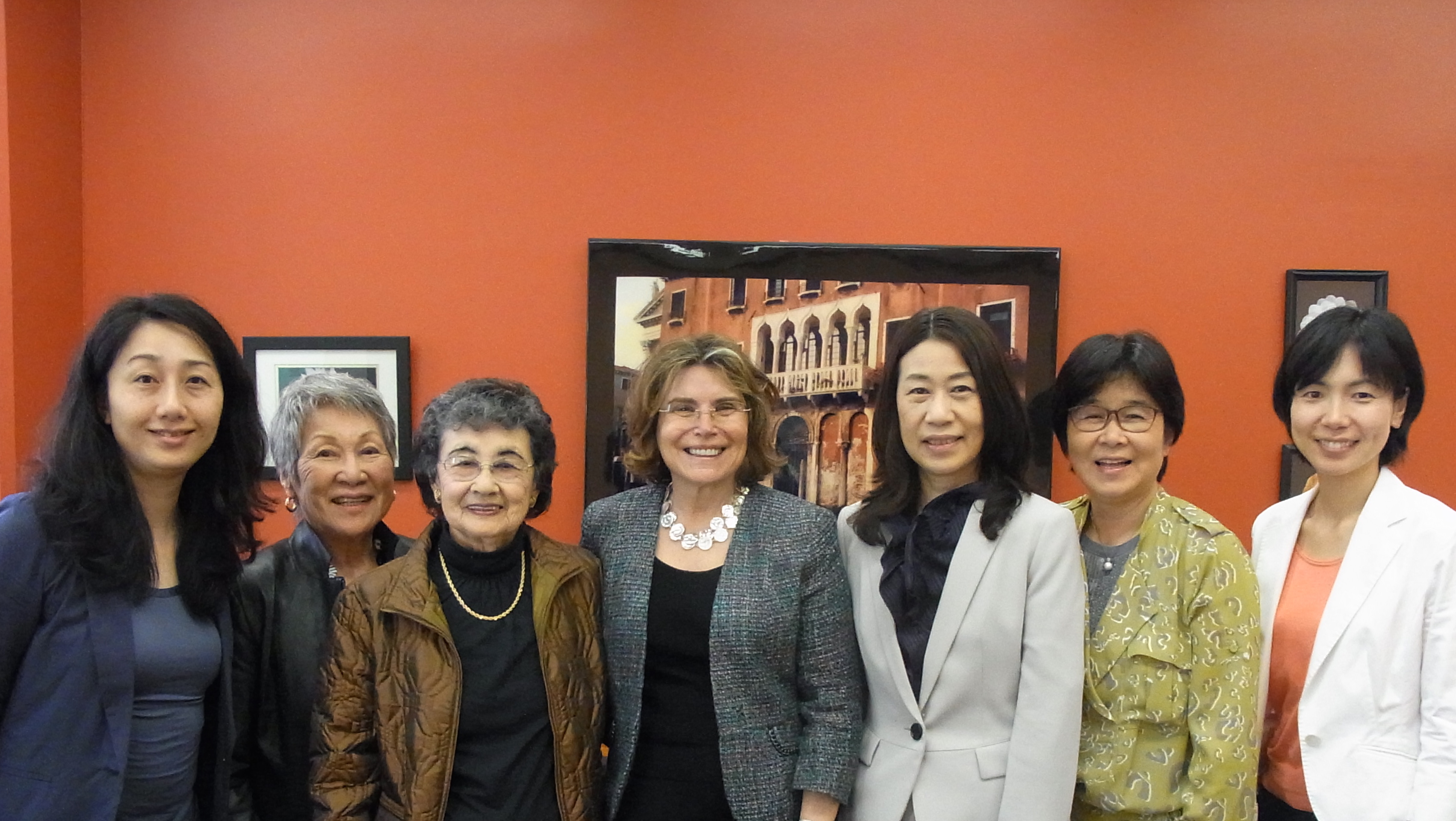 The group takes a photograph with School of Medicine Professor Robyn Gershon (middle).