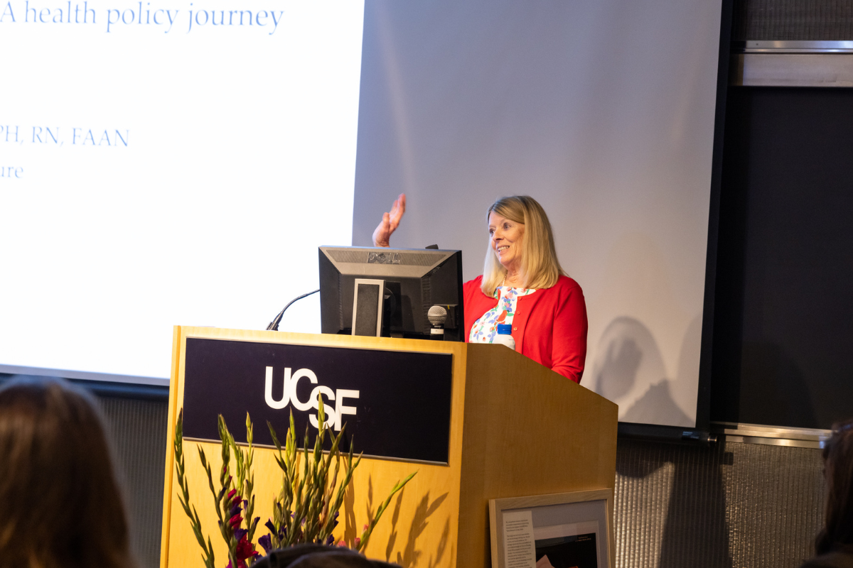 Susan Chapman stands at podium