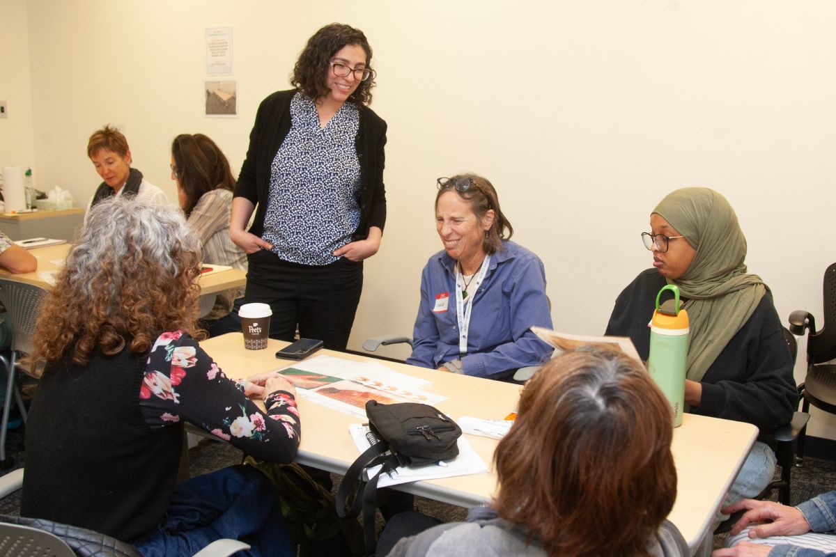 Nouredini speaks with a small group of workshop participants