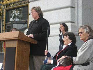 Catherine Dodd speaks in front of San Francisco City Hall