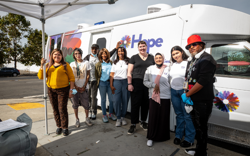 HOPE Mobile Clinic team members stand in front of the medical van