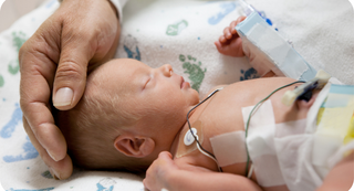 Infant in hospital bassinet