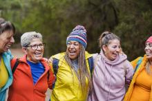 Five women stand together