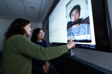 Student and instructor looking at an image on a screen