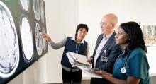 Three people look at X-rays