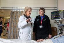 Michele Pelter, PhD, RN, speaks to Kirsten Fleischmann, MD, MPH, and a patient from a hospital room in the cardiac ICU. 