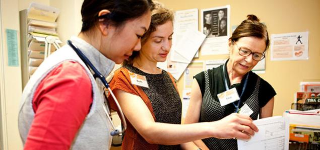 Residents Vivian Sha (left) and Beth Goldstein (center) consult with NP Tina Clark at Glide Health Services clinic in San Francisco (photos by Elisabeth Fall).