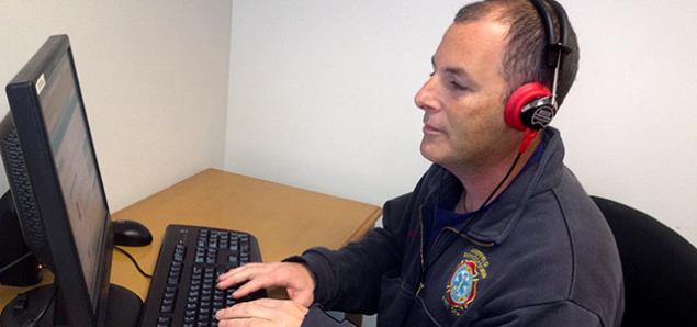 A firefighter participates in internet-based, hearing-loss training.
