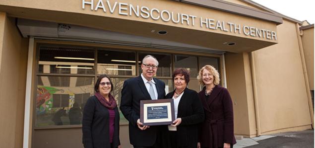At Havenscourt Health Center, partners in Elev8 from UC San Francisco School of Nursing and the Alameda County Center for Healthy Schools and Communities celebrate recognition from the American Association of Colleges of Nursing. From left are: Naomi Schapiro, director of the Elev8 program for the School; Dean David Vlahov; Tracy Schear, director of the Center for Healthy Schools and Communities and Linda Franck, chair of the School's Department of Family Health Care Nursing.