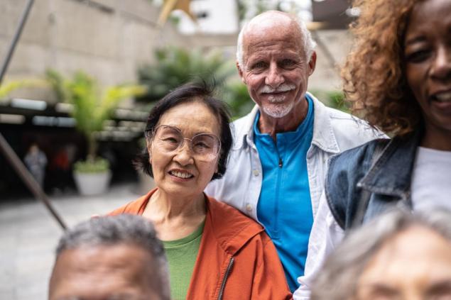 Five adults standing outside