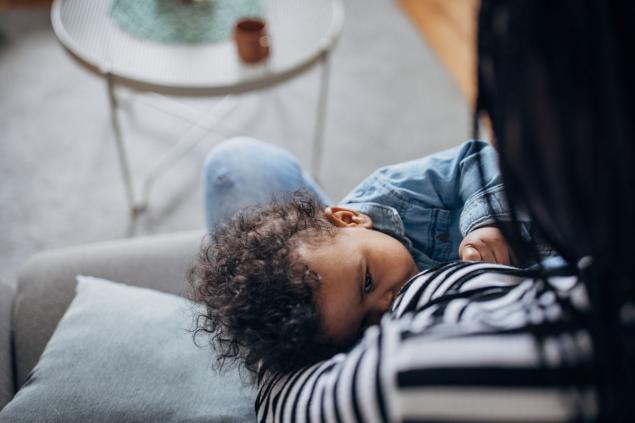 Adult breastfeeding an infant