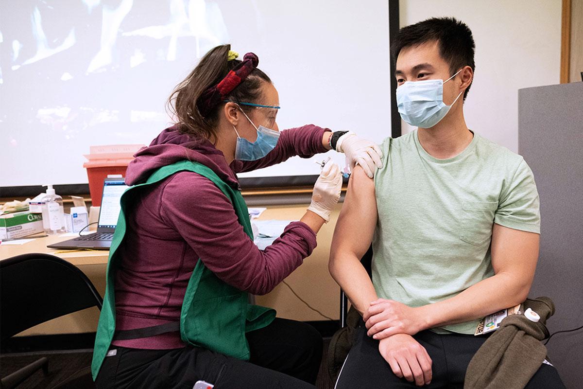 UCSF nursing student administering COVID vaccine