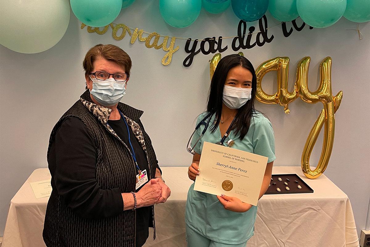 Sherryl Anne Perez receives certificate from MEPN Interim Director Mary Foley.