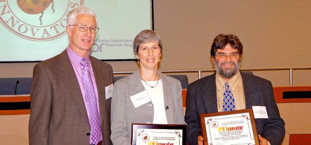 Abbey Alkon (center) and Asa Bradman (right) accept their Integrated Pest Management Innovator award. 