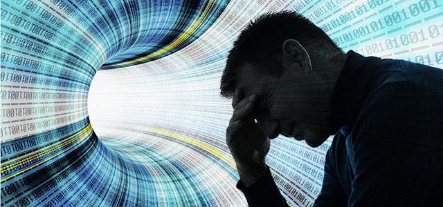 Image of a person resting their head on their hand, in front of a colorful background of datasheets.