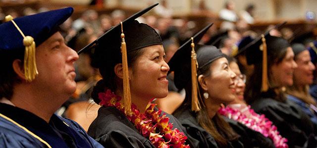 Students sit in the auditorium during their graduation ceremony.