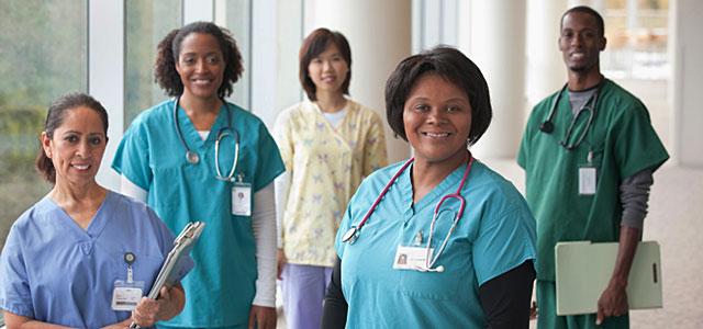 Five health care providers stand, facing the camera.