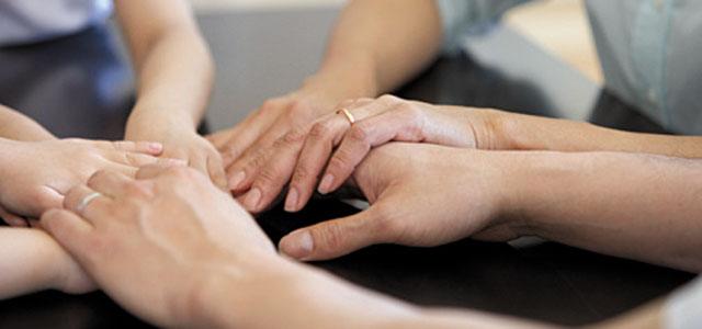 Three people holding hands.