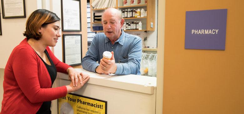 Psychiatric/mental health nurse practitioner Jamie Sanders consults with pharmacist Lester Bornheim at Marin Community Clinics (photo by Elisabeth Fall).