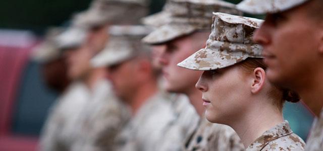 A group of soldiers stand at attention.