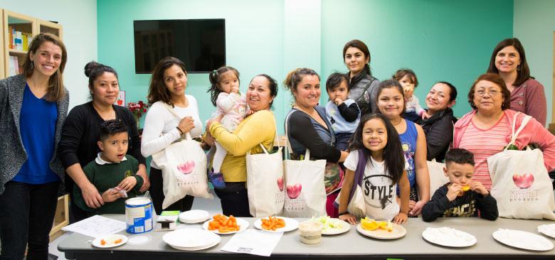 Nadia Al-Lami (left) and Victoria Keeton (right) with Head Start families after a nutrition class  (photos by Elisabeth Fall)