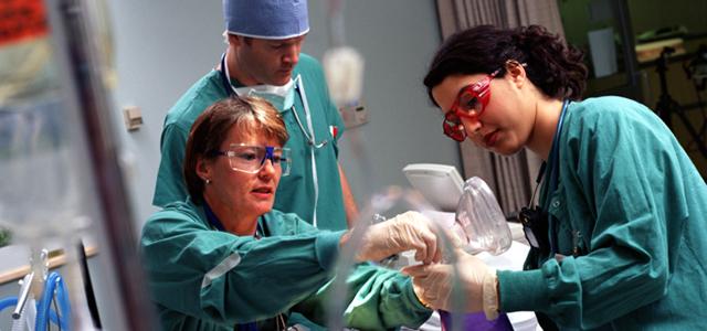 Nurses in a clinical room holding a manual pump CPR resuscitation Ambu bag