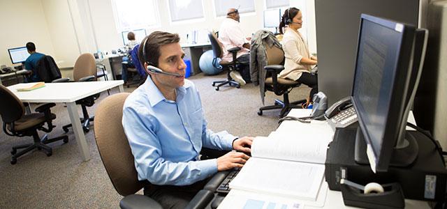 Nurse Practitioner Jonathan Van Nuys answers the telephone hotline at the National HIV/AIDS Clinicians’ Consultation Center at San Francisco General Hospital (photos by Elisabeth Fall).