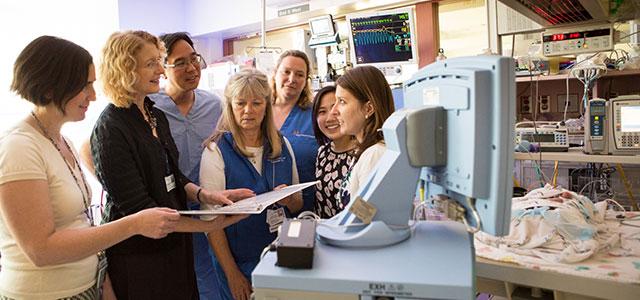 Interdisciplinary team members in the intensive care nursery. From left to right: pediatric pharmacist Sarah Scarpace Lucas, School of Nursing faculty member Linda Franck, neonatologist Thomas Shimotake, clinical nurse specialist Linda Lefrak, nurse Robin Bisgaard, research assistant Fiona Ng and pediatric pharmacy resident Sylvia Stoffella (photos by Elisabeth Fall).