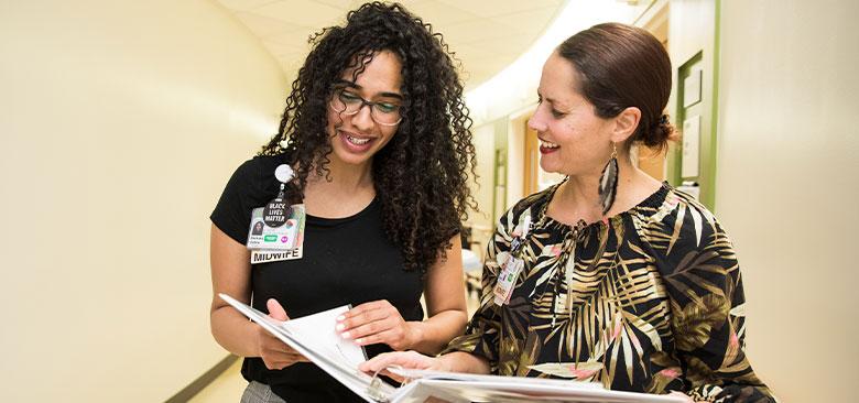 Asmara Gebre (left), certified nurse midwife at Zuckerberg San Francisco General Hospital, and Ana Delgado, director of inpatient midwifery services at ZSFGH,  are addressing racism in pregnancy and birth care, and providing care to pregnant individuals with substance use disorders. (Photo credit: Elisabeth Fall) 