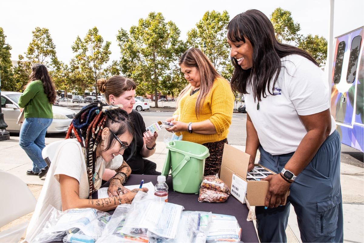 Natalie Wilson and members of the HOPE mobile clinic team hand out hygiene kits in Oakland.