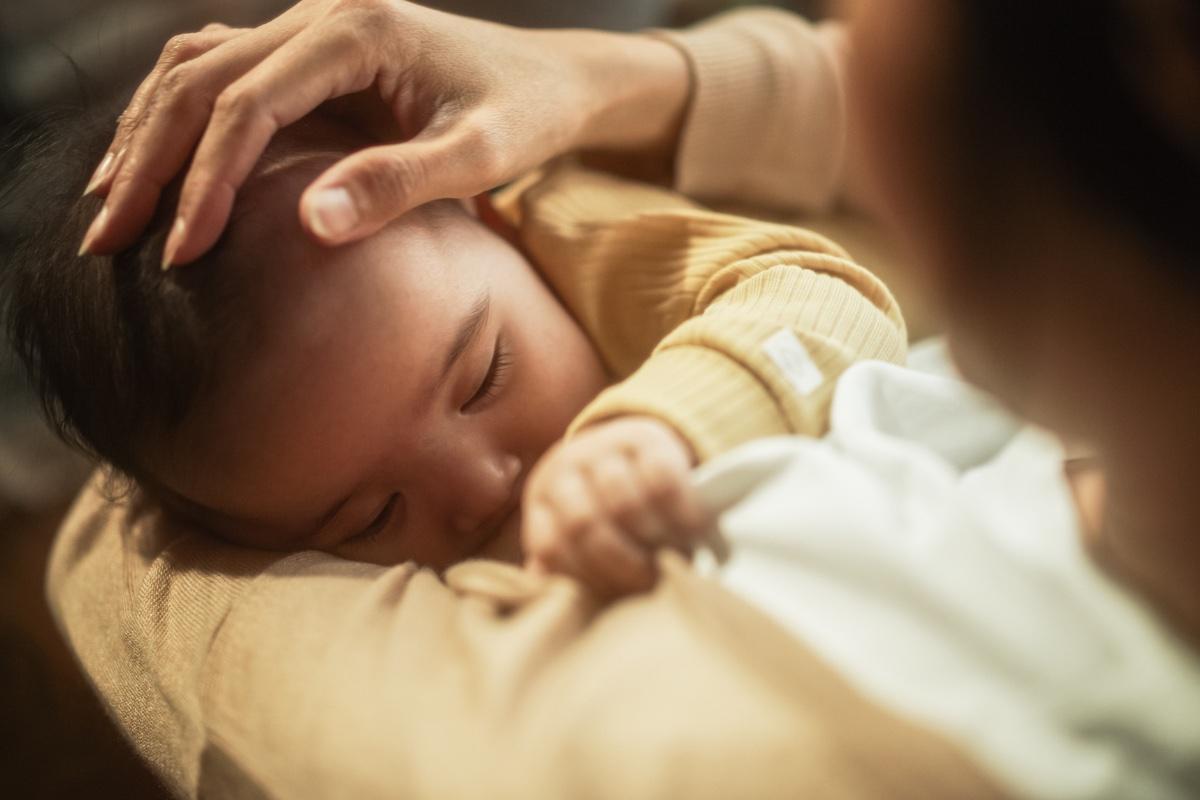 Infant being fed by parent