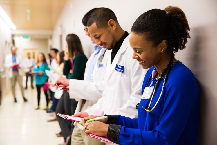 People standing in a hospital hallway.