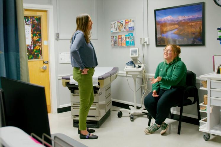 Nurse speaks to student in clinic