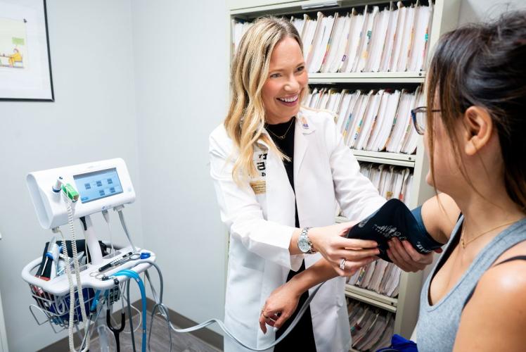 Nurse takes blood pressure of a patient.