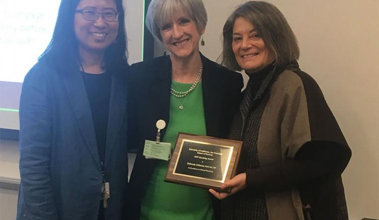Deborah Johnson (center) is recognized for Excellence in Clinical Mentoring. Also pictured are Soo-Jeong Lee (left), chair of the Faculty Council, and Dean Catherine L. Gilliss.